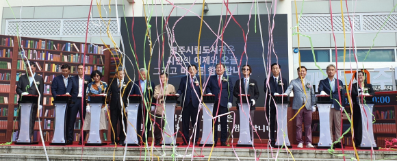 경주시립도서관은 개관 70주년에 참석한 인사들이 축하 퍼포먼스를 하고 있다.