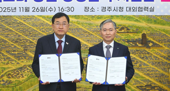 주낙영 경주시장(왼쪽)과 권원택 한국수력원자력 월성원자력본부장이 26일 경주시청 대외협력실에서 월성원전 맥스터 증설 상생협력 지원금 협약을 체결한 뒤 협약서를 들어 보이고 있다.